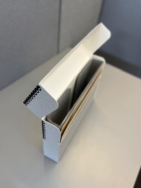 Document Spacer: Small archival storage box with a one folder collection held upright by a document spacer
