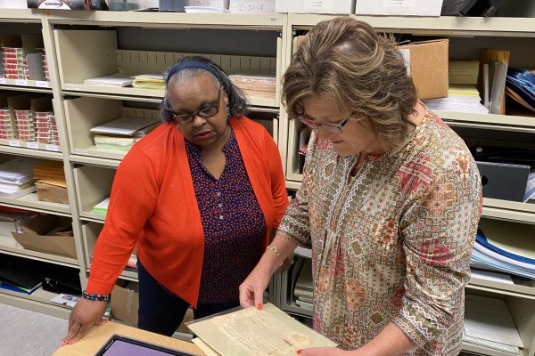 Henry County circuit court clerk, Jennifer Ashworth (right) and chief deputy clerk, Francis Wade review some of the recently rediscovered records related to the founding and early history of Henry County, 1774-1833.